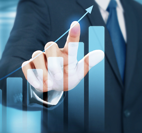 A man in a suit touches a transparent bar graph, indicating growth with an upward arrow. The image conveys progress and success in a business setting.